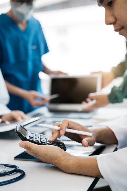 Doctors use a service fee calculator to save money on health insurance, drug cost concepts.